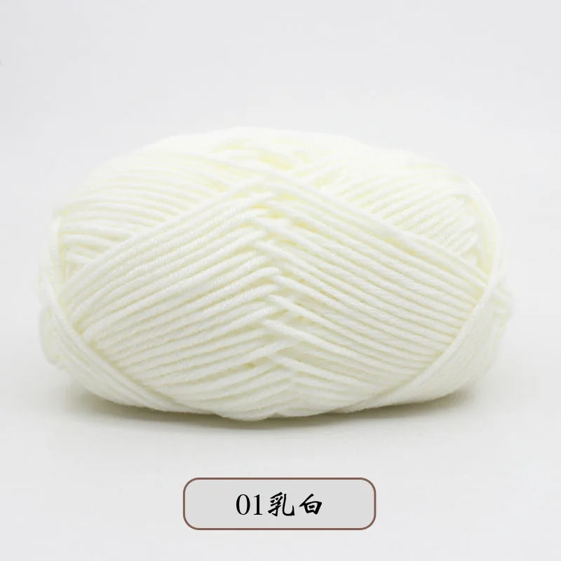 A ball of white pre-dyed milk cotton yarn for knitting and crochet.