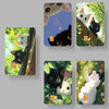 A set of four watercolor illustrations featuring cute black and white cats in various outdoor settings.