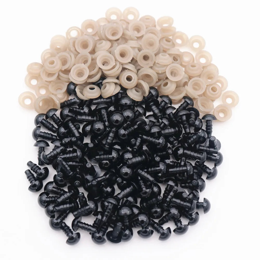 A pile of black plastic safety eyes with washers and a pile of beige plastic safety eyes.