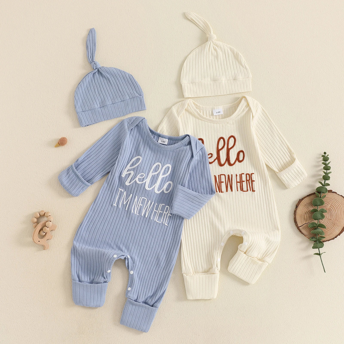 A baby boy long sleeve ribbed romper and matching knit hat in light blue and cream colors.