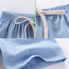 Light blue linen shorts with an adjustable drawstring waist shown in detail and full view.