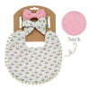 A pink and white baby flower bib and headband set with a bow