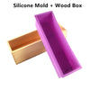A rectangular silicone mold with a purple interior is shown alongside its natural wood box casing.