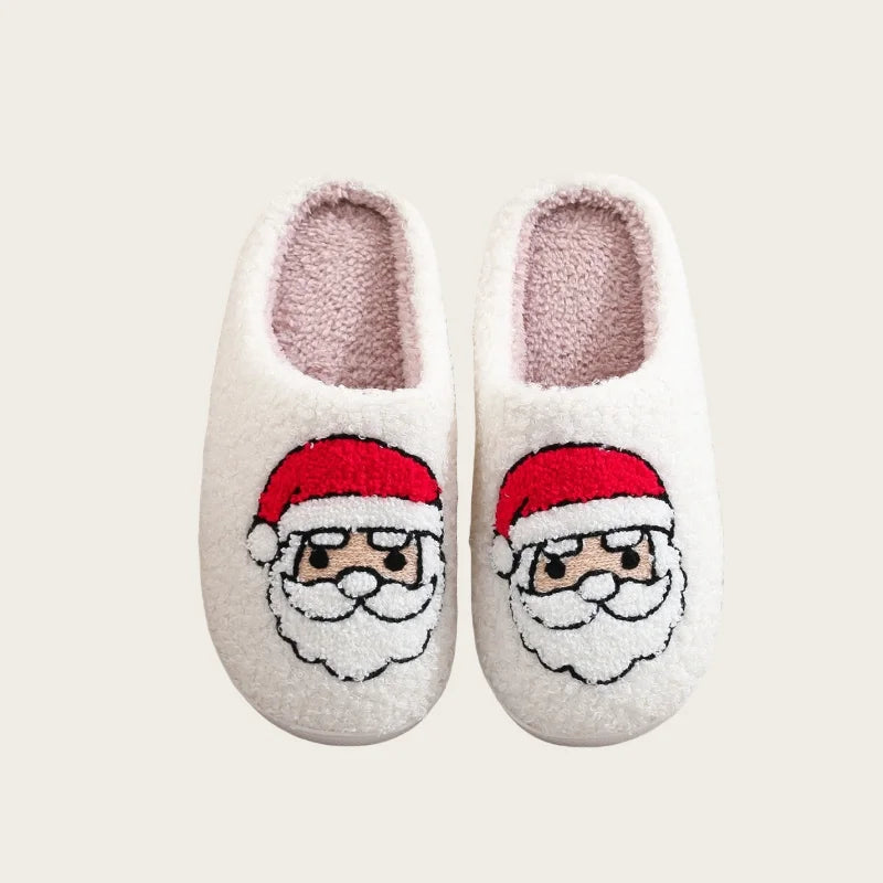 A pair of white plush indoor slippers decorated with a red Santa beard and hat.