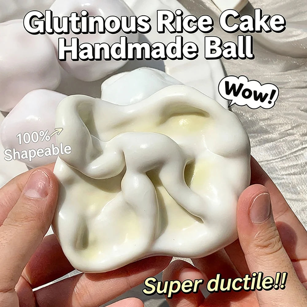 A hand holds a white glutinous rice cake handmade ball squishy stress toy