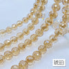 A set of 20 clear amber crystal beads with an AB coating arranged in strands.