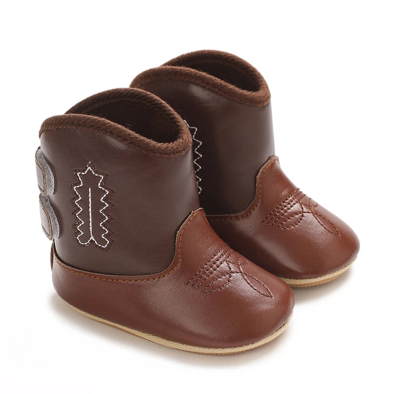 A pair of brown baby western booties with a soft non-slip sole.