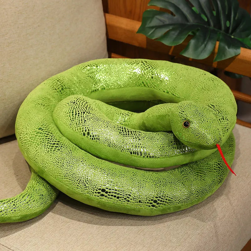 A bright green realistic giant snake plush toy coiled on a light-colored surface.