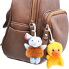 A brown leather pouch with zippered compartments featuring a white and yellow plush animal keychain set.