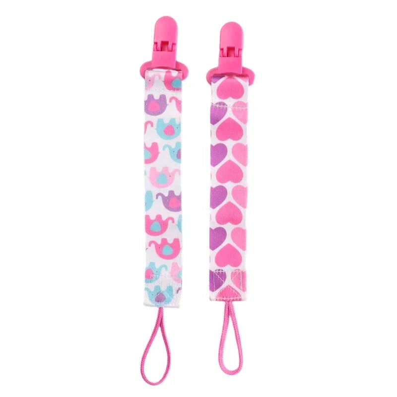 Set of four soft pacifier clips with double-sided prints for babies in pink and blue