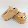 A pair of tan Rilakkuma plush indoor slippers with yellow accents.