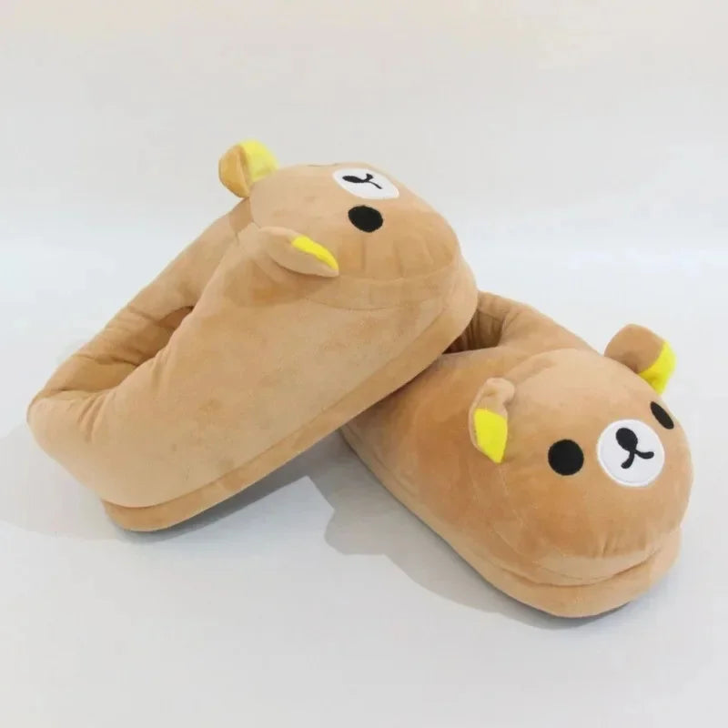 A pair of tan Rilakkuma plush indoor slippers with yellow accents.