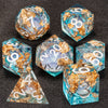 A set of liquid core dice including a d6, d8, d10, d20, and d30 in various shades of blue and gold.