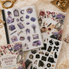 A collection of vintage scrapbook stickers, including floral elements, jewelry, and gothic motifs, displayed on a white page.