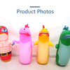 Four inflatable dinosaur punching bag tumbler toys in pink, purple, orange, and green.
