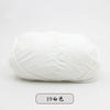 A ball of white pre-dyed milk cotton yarn for knitting and crochet.