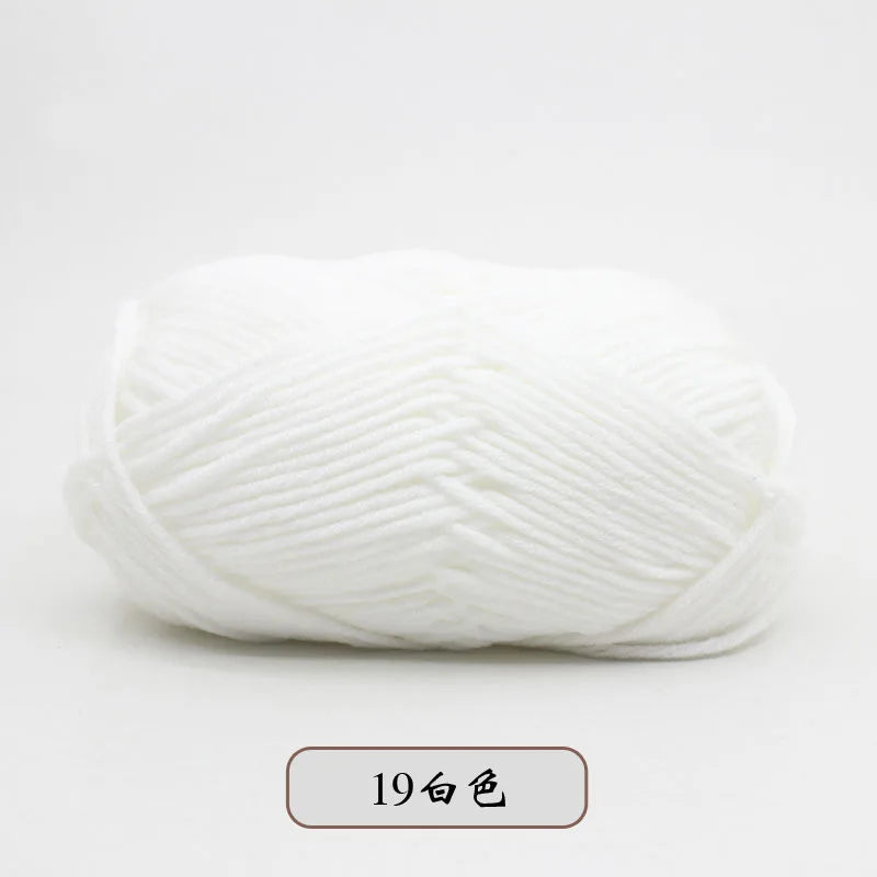 A ball of white pre-dyed milk cotton yarn for knitting and crochet.