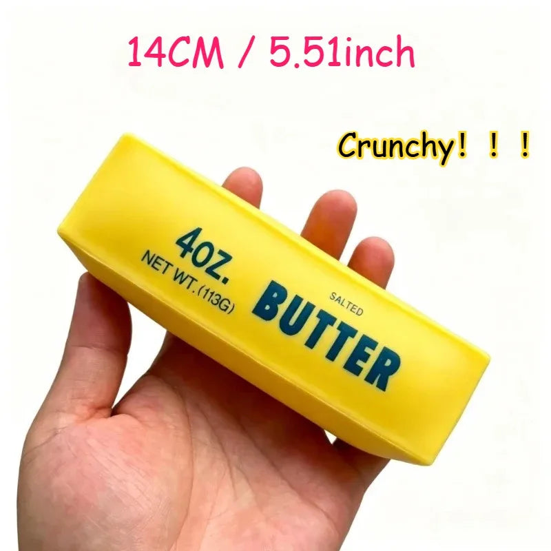 A hand holds a yellow butter stress ball labeled 40 oz salted butter with a crunchy texture.