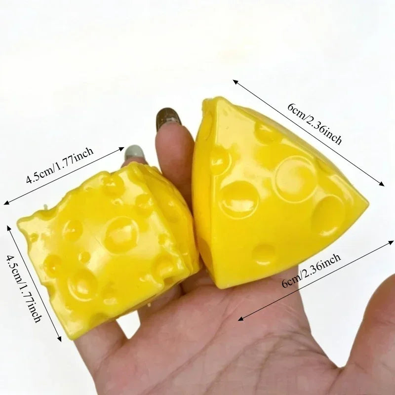 A yellow, squishy cheese ball stress relief squeeze toy is held in a hand, showing its size and texture.