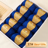 A box of Merino wool yarn balls with yellow labels showing the weight 37# and quantity 10 pieces totaling 500g