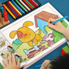 A child is drawing a yellow dog on a colorful page in a kids drawing and coloring book.