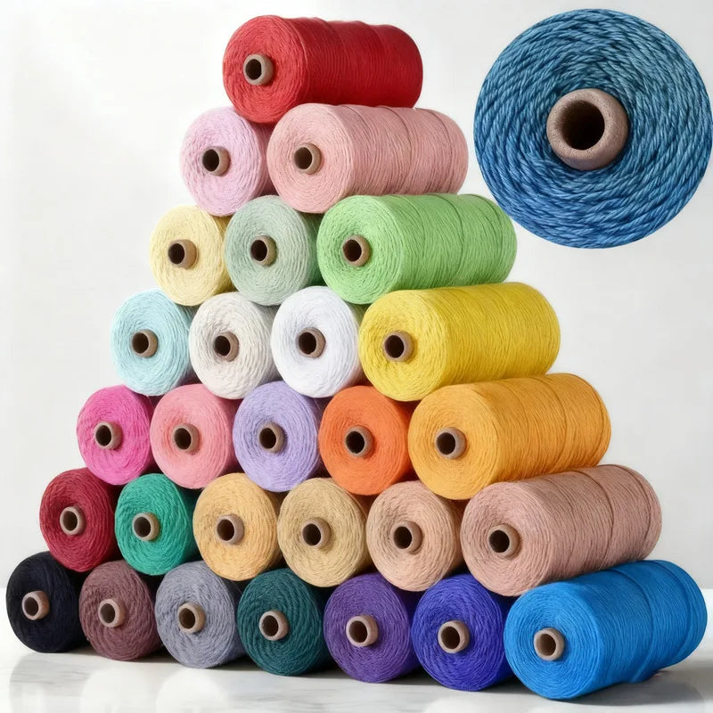 A collection of spools of 3mm cotton macrame cord in various shades of pink, green, yellow, and blue.