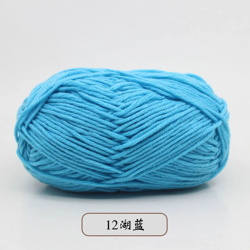 A ball of light blue pre-dyed milk cotton yarn used for knitting and crochet.