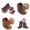 A collection of brown and pink baby Western booties with non-slip soles shown from various angles.