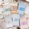 A collection of vintage and textured paper products including coffee dye paper, watercolor paper, and patterned shadows sheet