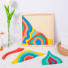 Rainbow wooden blocks puzzle inside a wooden frame with a floral arrangement.