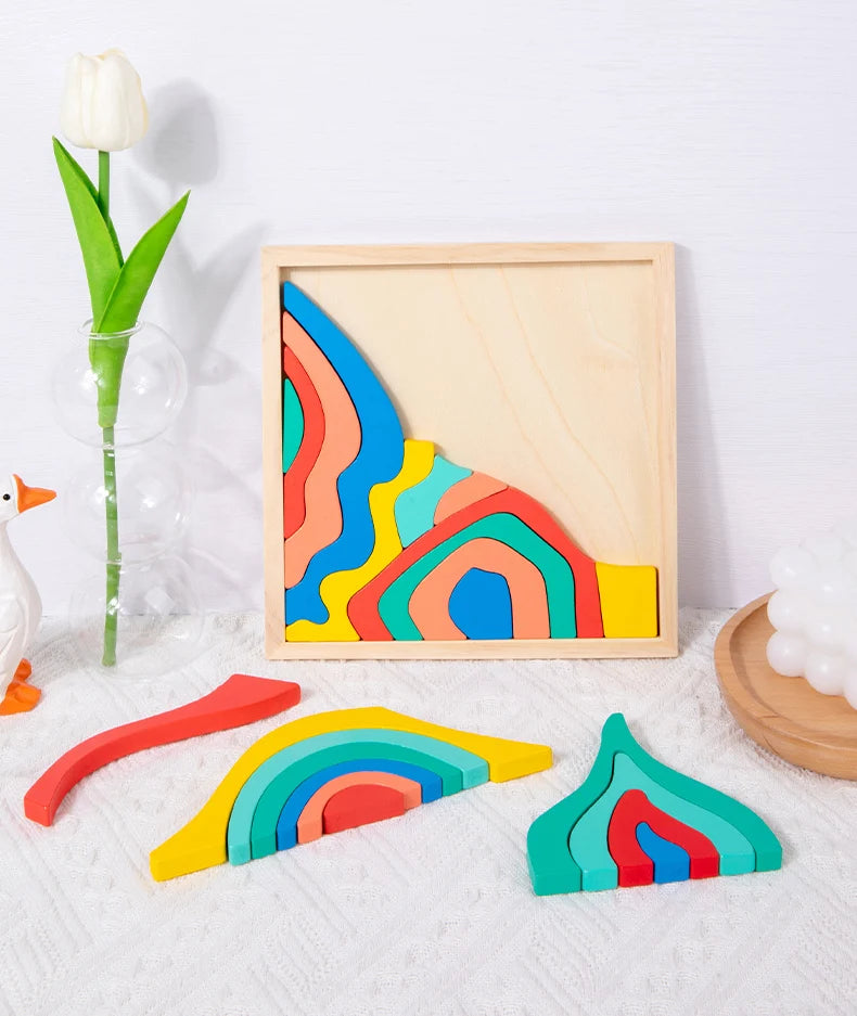 Rainbow wooden blocks puzzle inside a wooden frame with a floral arrangement.