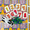 A colorful board game layout featuring numbered cards and components for a family game.