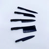 A set of four miniature black metal kitchen knives displayed on a white background.