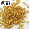 A pile of 1000 small, gold-colored fuse beads for creative craft projects.