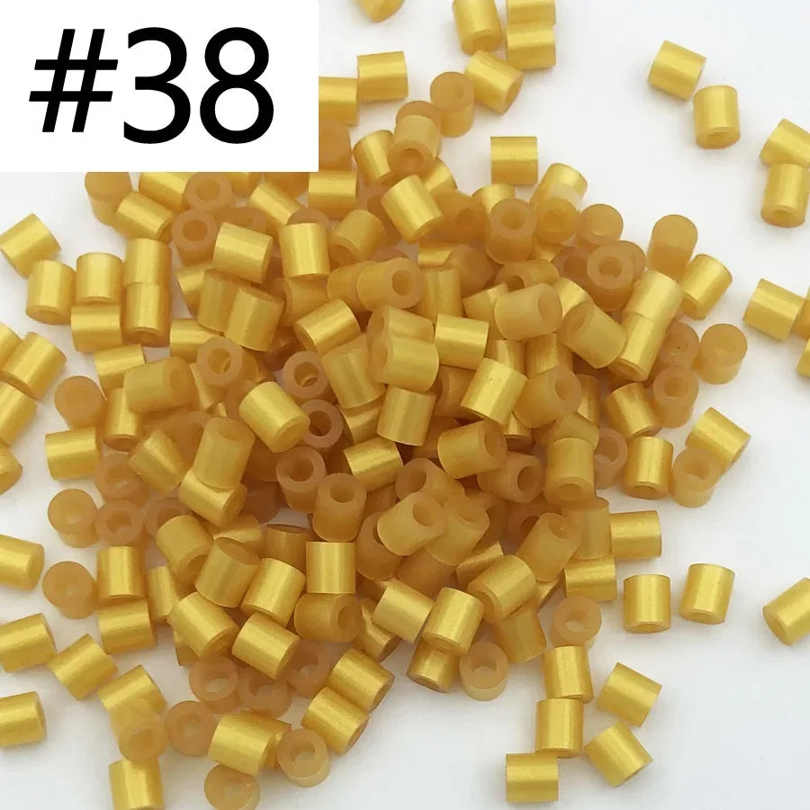 A pile of 1000 small, gold-colored fuse beads for creative craft projects.