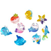 A collection of colorful resin charms shaped like various cute ocean animals including a yellow fish, a pink strawberry, and 