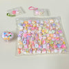 A clear plastic bag filled with numerous colorful kawaii cat paw squishy stress relief fidget toys and some loose pieces.