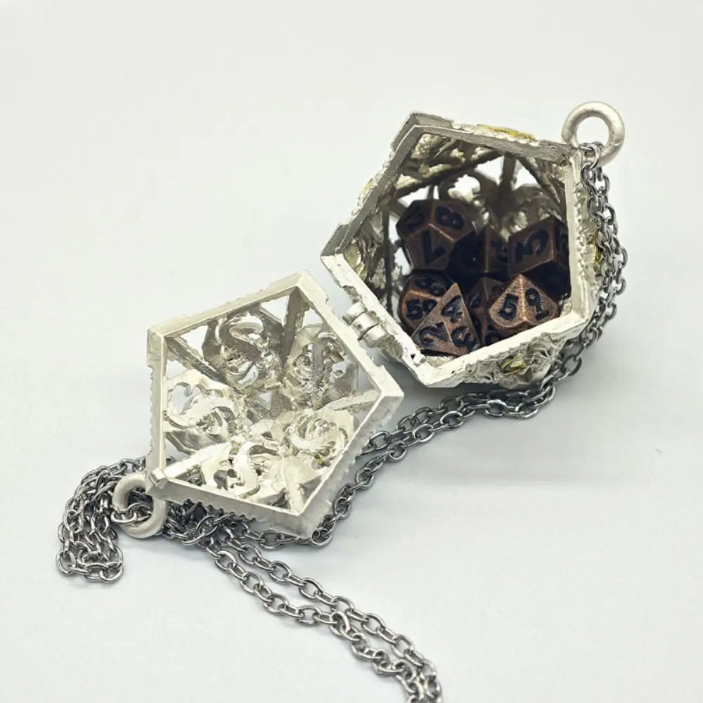 Silver metal polyhedral dice set with an open pendant storage case attached to a chain.