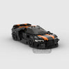 A black and orange classic supercar model built from building blocks.