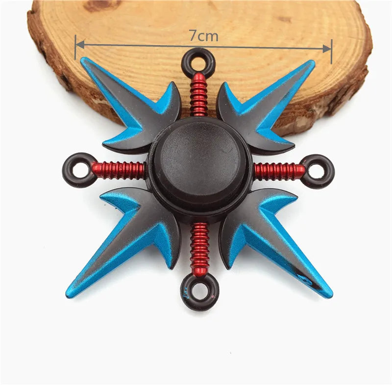 A metal fidget spinner with a rainbow finish, featuring black and blue blades and red accents.