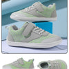 A pair of light green and gray minimalist sneakers with a textured upper and white sole.