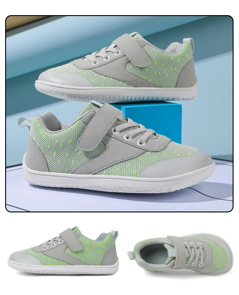 A pair of light green and gray minimalist sneakers with a textured upper and white sole.