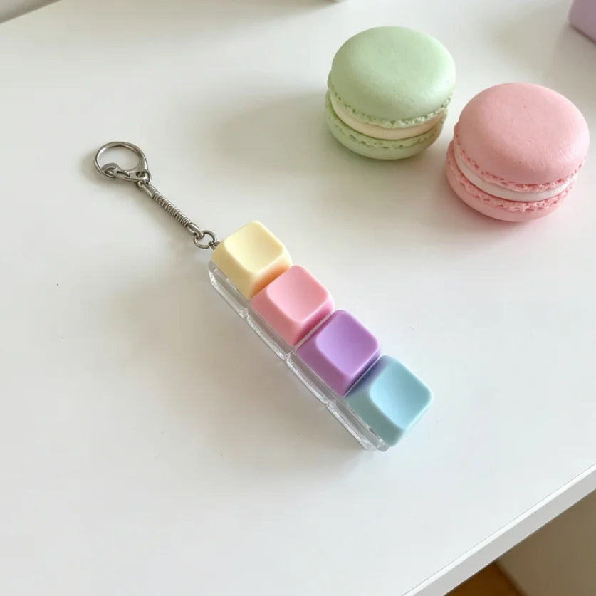 A keychain fidget toy featuring colorful, square silicone pieces attached to a silver keyring.