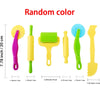 A set of colorful silicone tools for creative play dough including a pink, yellow, lime green, and blue tool.