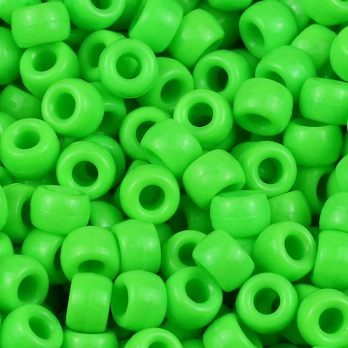 A pile of bright green pony beads for jewelry making and crafts.