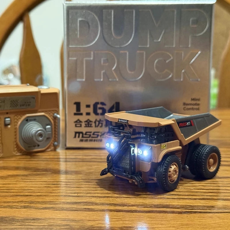 A scale model dump truck is displayed in front of a box labeled 1:64 Dump Truck.