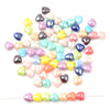 A collection of multicolored heart-shaped acrylic beads in various shades of pink, green, blue, and yellow.
