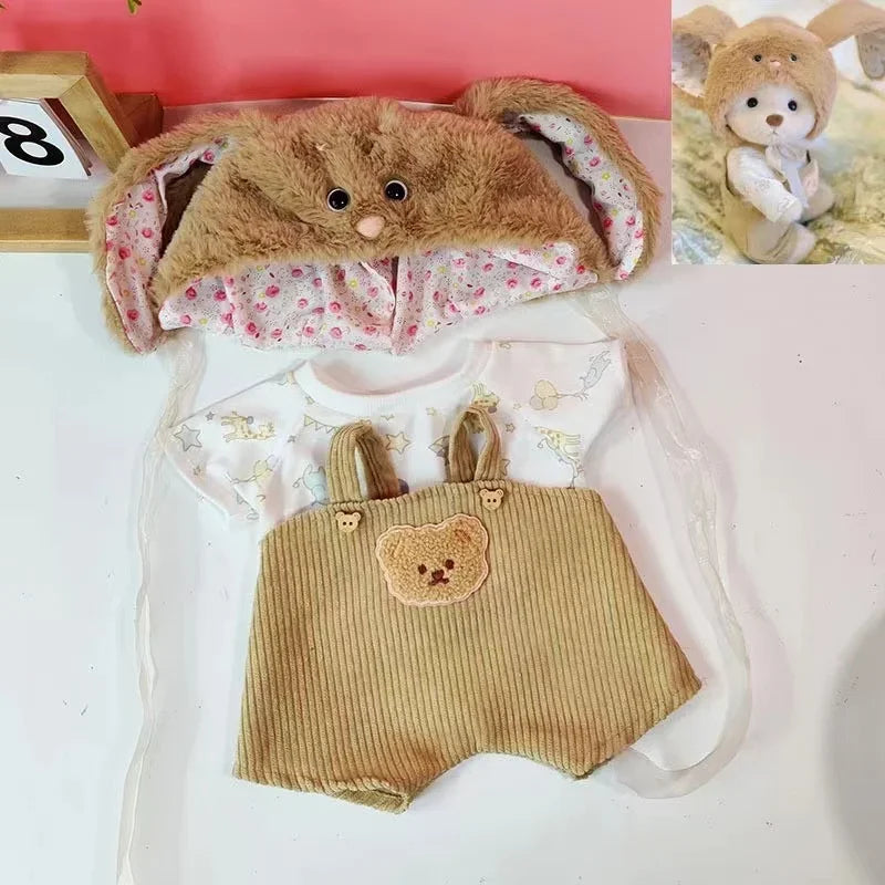A fluffy brown teddy bear plush toy with a pink floral dress and a beige knitted outfit.