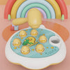 A yellow wooden hammer toy shaped like an animal, surrounded by a rainbow arch and various colorful blocks.