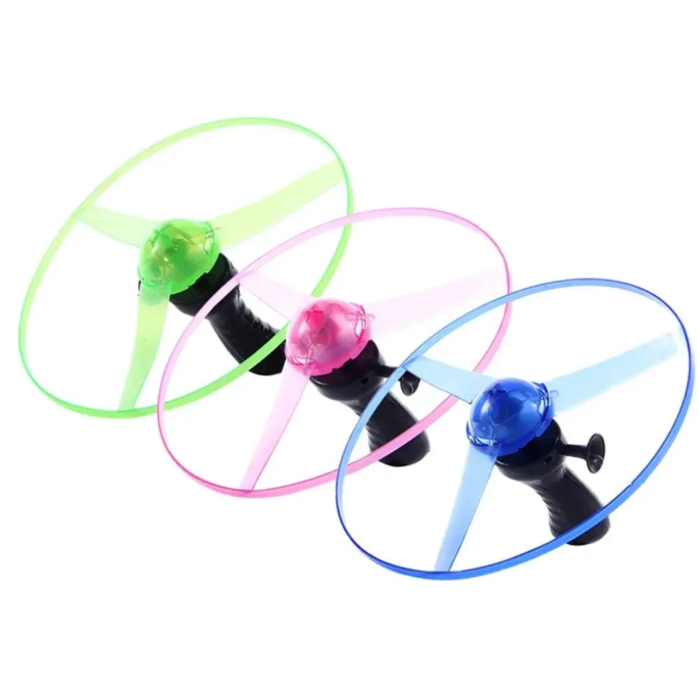 Glowing UFO spinning top toy with pull string featuring LED flying discs in green, pink, and blue colors.